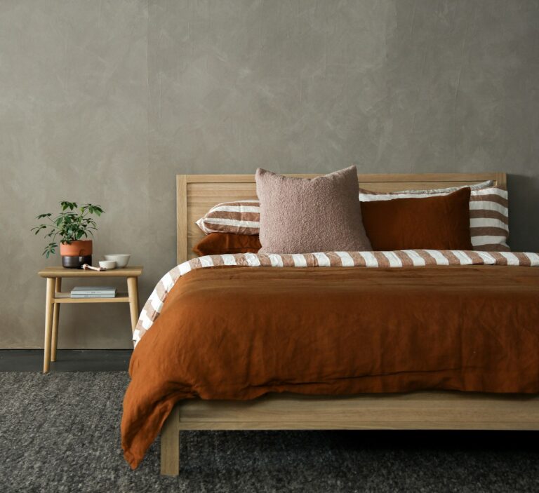 Soft upholstered fabric wall panels behind a bed